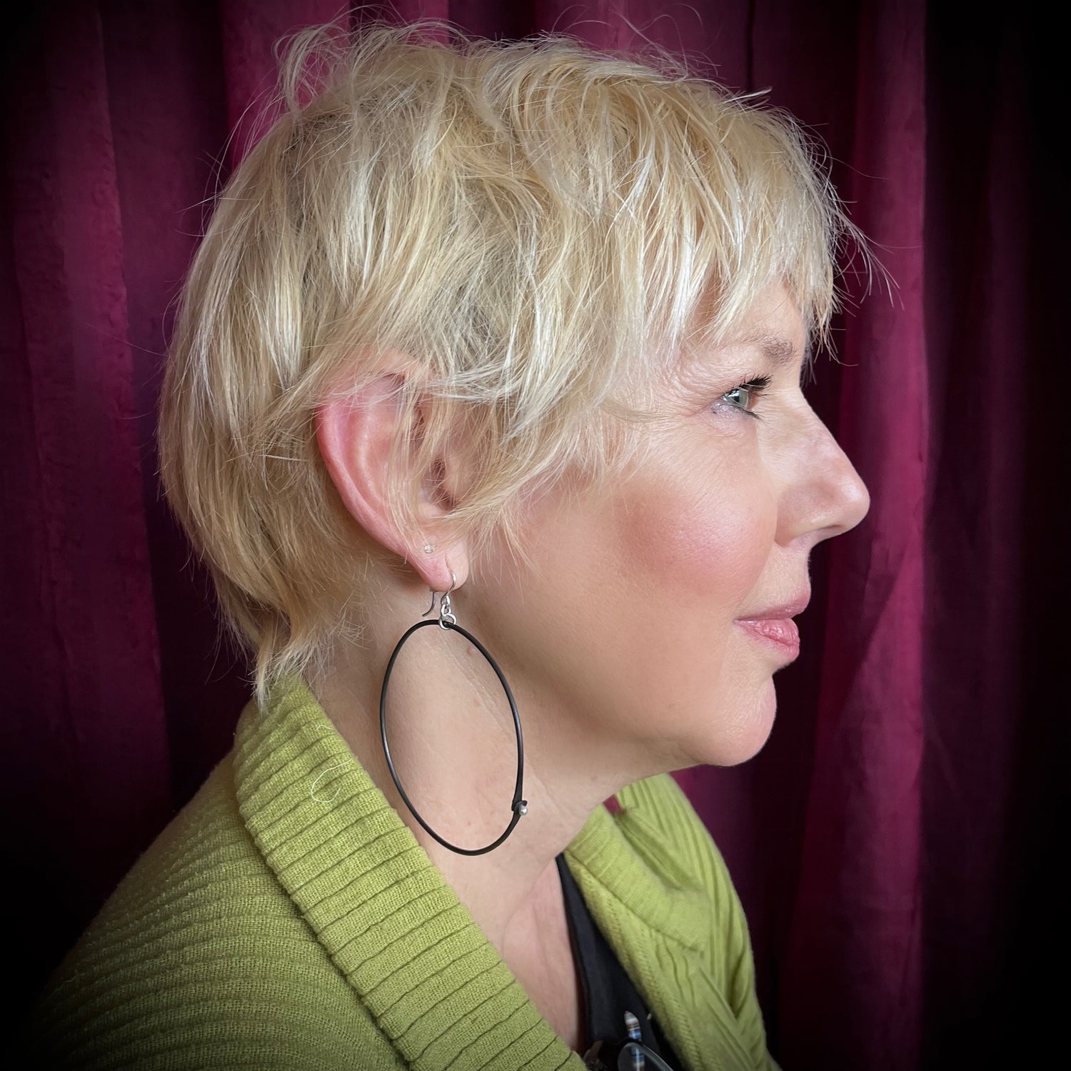 woman with x-large black hoop earrings on